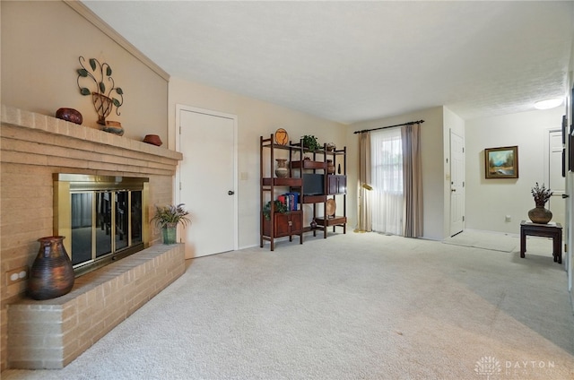 348 Cambridge Dr, Fairborn, OH 45324 - carpeted living room featuring a brick fireplace and baseboards