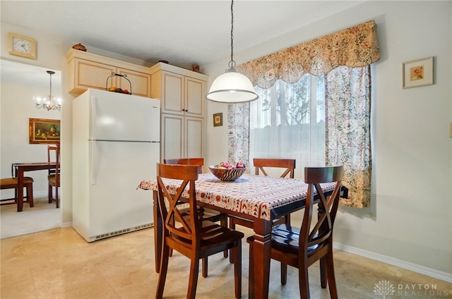 348 Cambridge Dr, Fairborn, OH 45324 - dining area featuring a chandelier and baseboards