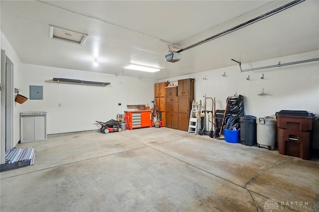 348 Cambridge Dr, Fairborn, OH 45324 - garage featuring electric panel and a garage door opener