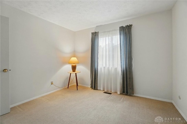 348 Cambridge Dr, Fairborn, OH 45324 - carpeted spare room with baseboards and a textured ceiling