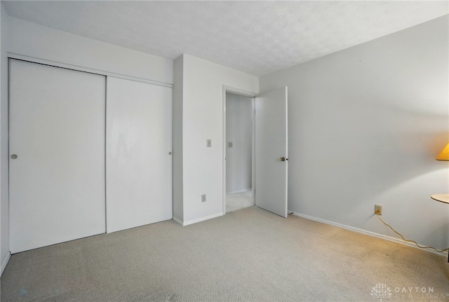 348 Cambridge Dr, Fairborn, OH 45324 - unfurnished bedroom featuring light colored carpet, a closet, and baseboards