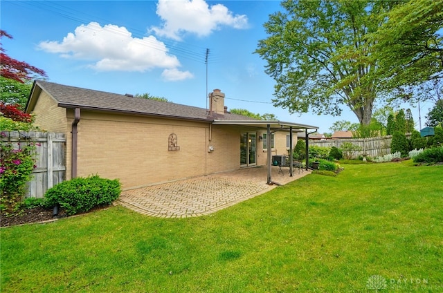 348 Cambridge Dr, Fairborn, OH 45324 - rear view of property with a chimney, a patio area, and brick siding
