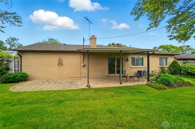 348 Cambridge Dr, Fairborn, OH 45324 - back of property with a patio area, a chimney, brick siding, and cooling unit