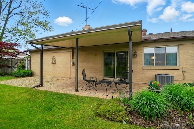 348 Cambridge Dr, Fairborn, OH 45324 - rear view of property with brick siding, a patio area, central AC unit, and a yard