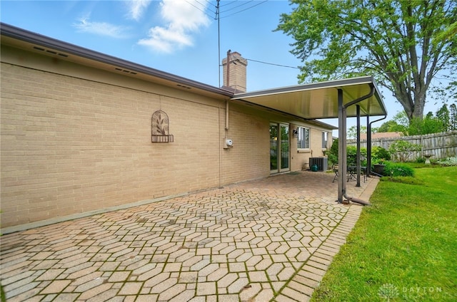348 Cambridge Dr, Fairborn, OH 45324 - rear view of property with central AC, a patio area, a chimney, and brick siding