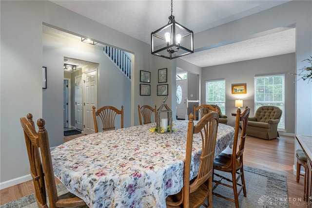 989 Brooke Ln, Xenia, OH 45385 - dining room with a chandelier, wood finished floors, and baseboards