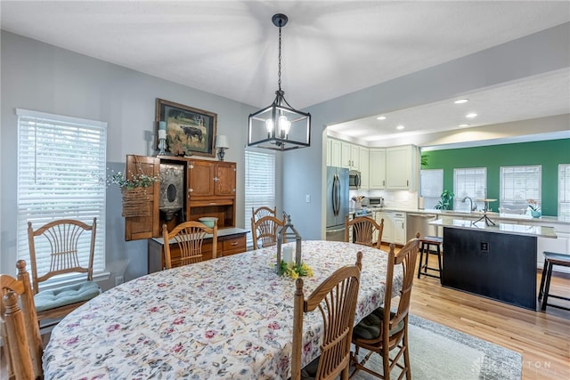 989 Brooke Ln, Xenia, OH 45385 - dining space featuring light wood finished floors, a chandelier, and recessed lighting