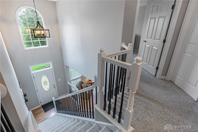 989 Brooke Ln, Xenia, OH 45385 - carpeted entrance foyer with a chandelier, plenty of natural light, a high ceiling, and baseboards