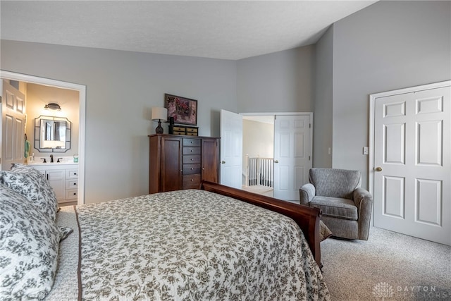 989 Brooke Ln, Xenia, OH 45385 - bedroom featuring lofted ceiling, carpet floors, and ensuite bathroom
