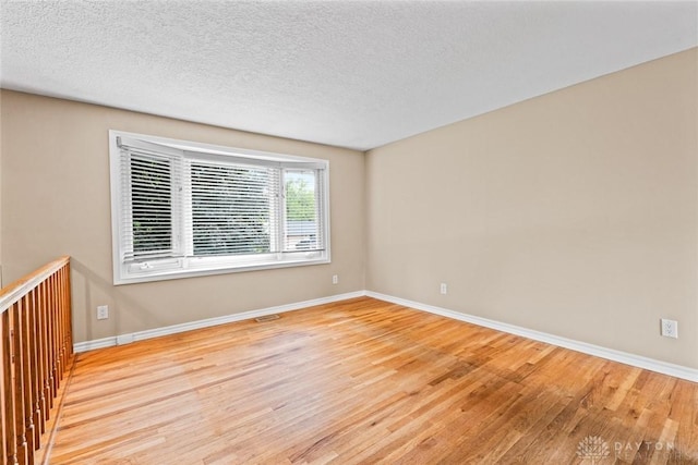 2707 Rockledge Trl, Beavercreek, OH 45430 - empty room with wood finished floors, baseboards, and a textured ceiling