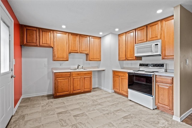 2707 Rockledge Trl, Beavercreek, OH 45430 - kitchen featuring white appliances, baseboards, light countertops, a sink, and recessed lighting