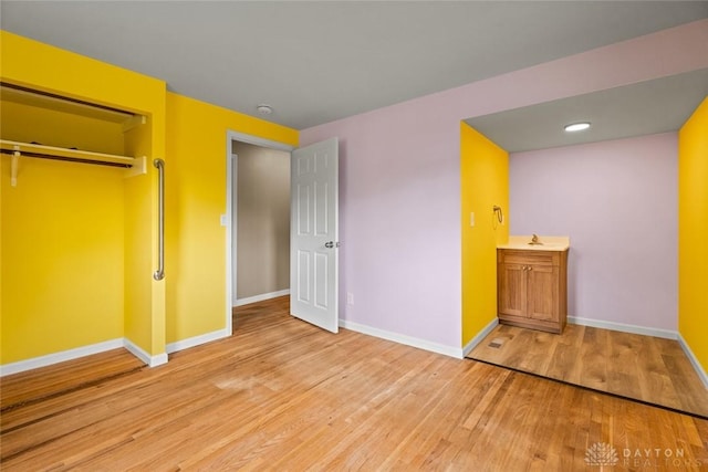 2707 Rockledge Trl, Beavercreek, OH 45430 - unfurnished bedroom with baseboards, light wood-style flooring, and a sink