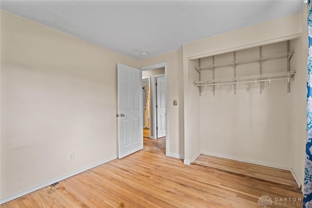 2707 Rockledge Trl, Beavercreek, OH 45430 - unfurnished bedroom featuring wood finished floors, baseboards, and a closet