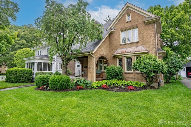 54 Beverly Pl, Oakwood, OH 45419 - view of front facade with brick siding, a front lawn, a shingled roof, and a porch