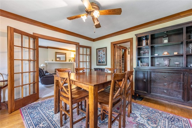 54 Beverly Pl, Oakwood, OH 45419 - dining space with ornamental molding, ceiling fan, light wood-style flooring, and french doors