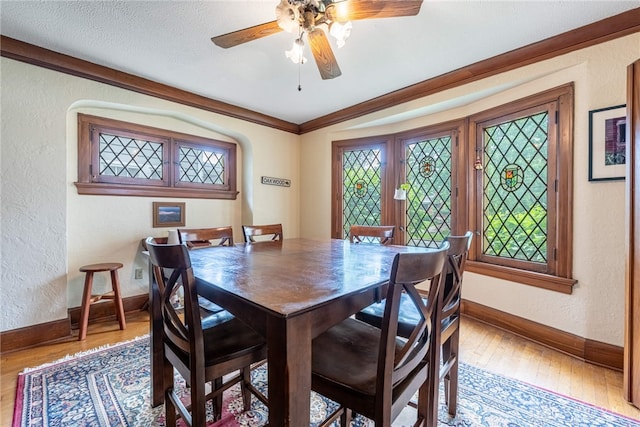 54 Beverly Pl, Oakwood, OH 45419 - dining area featuring a textured wall, baseboards, wood-type flooring, a ceiling fan, and crown molding