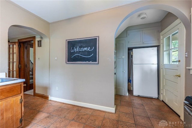 54 Beverly Pl, Oakwood, OH 45419 - kitchen featuring freestanding refrigerator, baseboards, arched walkways, and light countertops