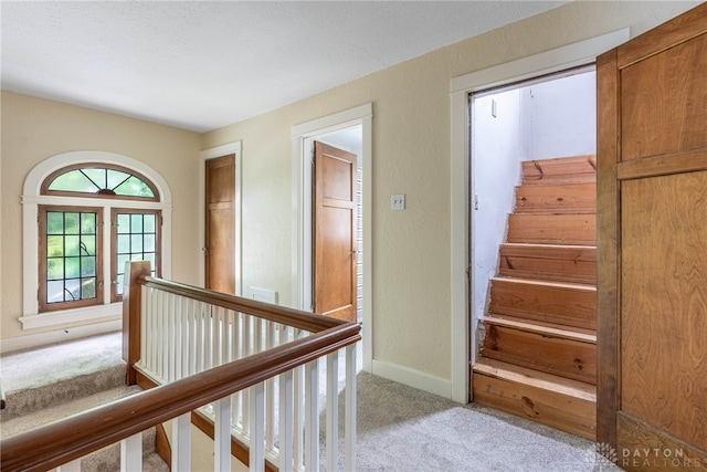 54 Beverly Pl, Oakwood, OH 45419 - hall featuring carpet floors, baseboards, a textured wall, and stairs