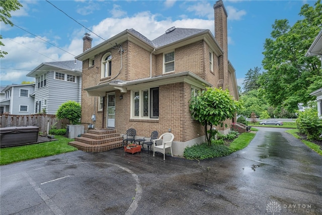 54 Beverly Pl, Oakwood, OH 45419 - view of front of property featuring a chimney, brick siding, and a hot tub