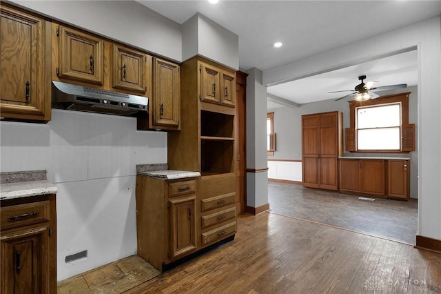 125 W Mound St, South Charleston, OH 45368 - kitchen featuring under cabinet range hood, a ceiling fan, brown cabinetry, wood finished floors, and recessed lighting