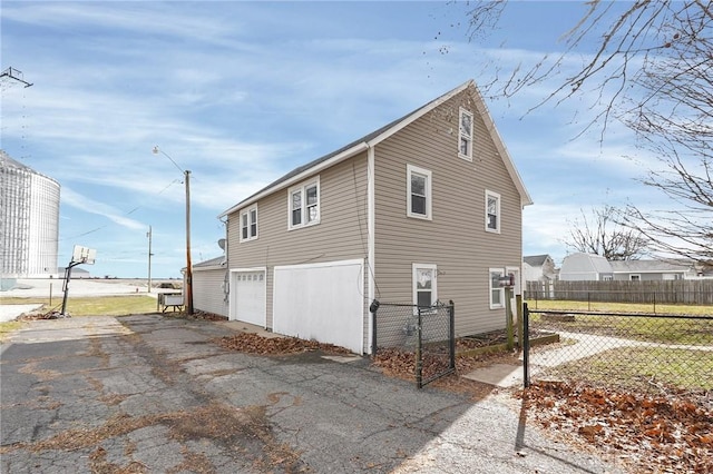 125 W Mound St, South Charleston, OH 45368 - view of property exterior featuring driveway and a garage
