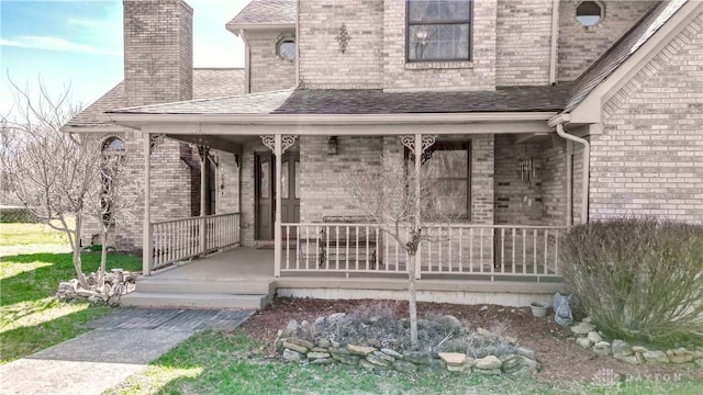 343 White Oak Dr, Chester Twp, OH 45177 - property entrance featuring a porch, a chimney, brick siding, and a shingled roof