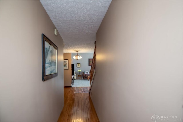 343 White Oak Dr, Chester Twp, OH 45177 - corridor with a textured ceiling, hardwood / wood-style flooring, a chandelier, and baseboards