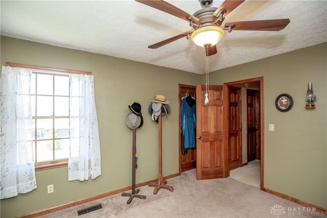 343 White Oak Dr, Chester Twp, OH 45177 - unfurnished bedroom with multiple windows, carpet, baseboards, and a textured ceiling