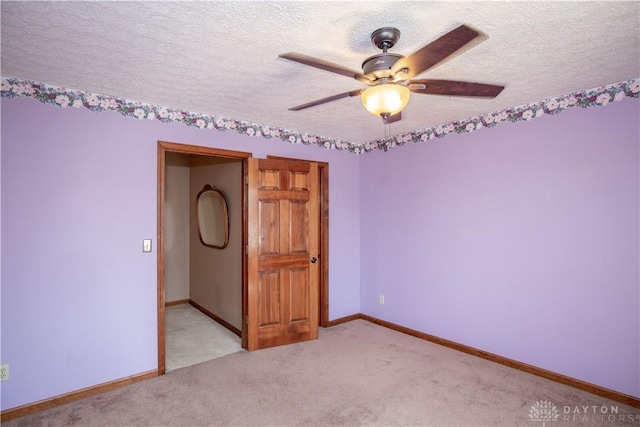 343 White Oak Dr, Chester Twp, OH 45177 - spare room featuring a textured ceiling, ceiling fan, light colored carpet, and baseboards