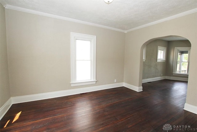 1716 Xenia Ave, Dayton, OH 45410 - empty room with arched walkways, dark wood finished floors, healthy amount of natural light, baseboards, and ornamental molding