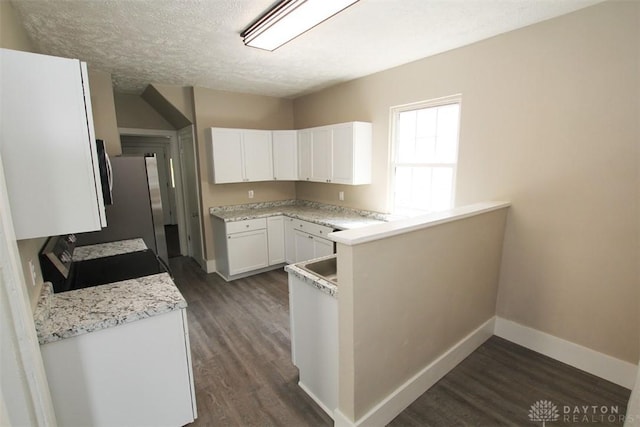 1716 Xenia Ave, Dayton, OH 45410 - kitchen with baseboards, dark wood-type flooring, stainless steel appliances, white cabinetry, and a textured ceiling