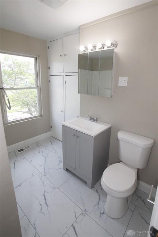 1716 Xenia Ave, Dayton, OH 45410 - bathroom featuring vanity, toilet, marble finish flooring, and baseboards
