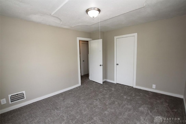 1716 Xenia Ave, Dayton, OH 45410 - unfurnished bedroom with dark carpet and baseboards