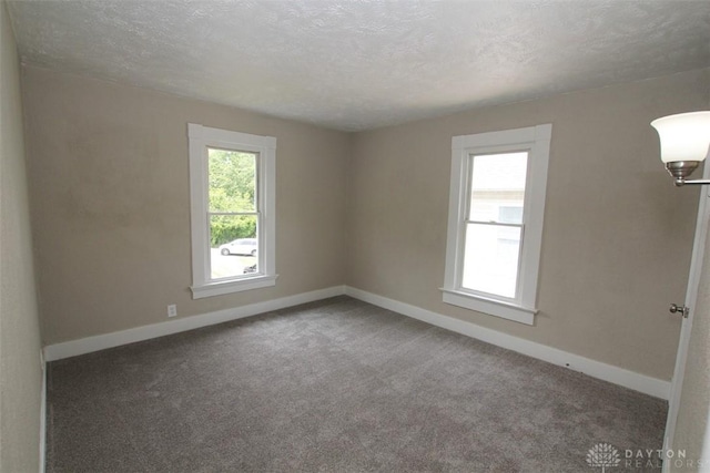 1716 Xenia Ave, Dayton, OH 45410 - carpeted spare room featuring baseboards and a textured ceiling