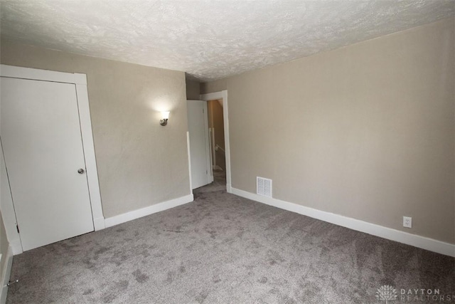 1716 Xenia Ave, Dayton, OH 45410 - unfurnished bedroom featuring carpet floors, a textured ceiling, and baseboards