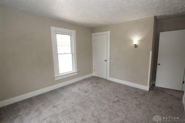 1716 Xenia Ave, Dayton, OH 45410 - carpeted empty room featuring a textured ceiling and baseboards