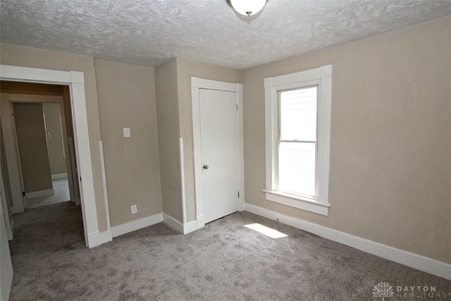 1716 Xenia Ave, Dayton, OH 45410 - unfurnished bedroom with a textured ceiling, baseboards, carpet flooring, and a closet