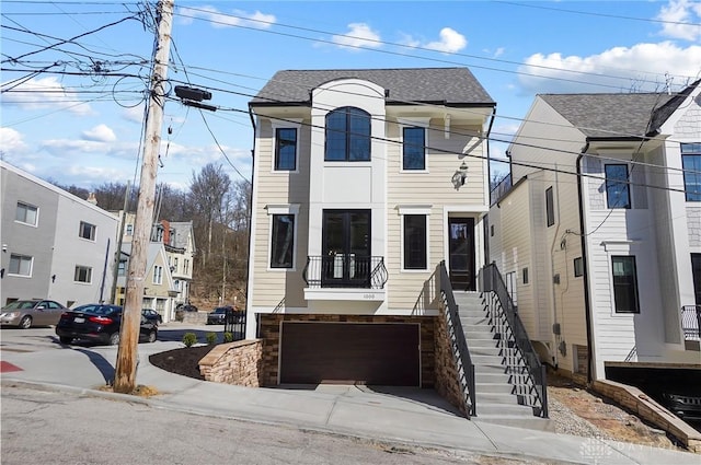 1000 Paradrome St, Cincinnati, OH 45202 - view of front of property featuring an attached garage, a shingled roof, and stairway