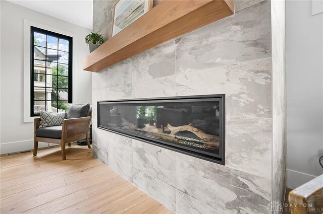 1000 Paradrome St, Cincinnati, OH 45202 - detailed view of a glass covered fireplace, wood finished floors, and baseboards