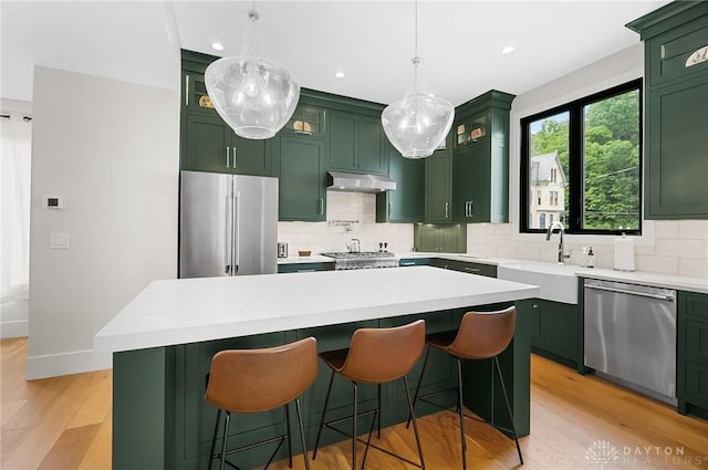 1000 Paradrome St, Cincinnati, OH 45202 - kitchen with green cabinetry, appliances with stainless steel finishes, under cabinet range hood, a sink, and recessed lighting