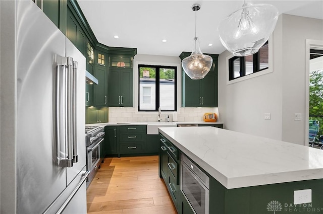 1000 Paradrome St, Cincinnati, OH 45202 - kitchen featuring green cabinets, high end appliances, a sink, plenty of natural light, and recessed lighting