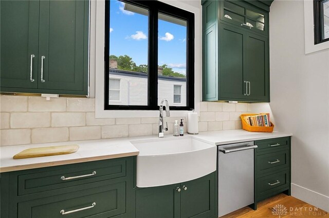 1000 Paradrome St, Cincinnati, OH 45202 - kitchen with green cabinetry, a sink, light countertops, and backsplash
