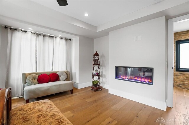 1000 Paradrome St, Cincinnati, OH 45202 - sitting room with a glass covered fireplace, light wood-type flooring, baseboards, recessed lighting, and brick wall