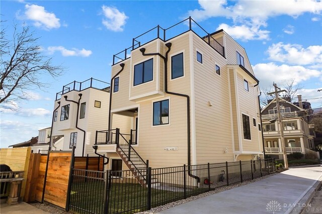 1000 Paradrome St, Cincinnati, OH 45202 - view of property exterior with a fenced front yard and stairway