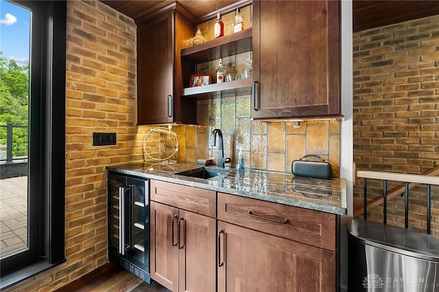 1000 Paradrome St, Cincinnati, OH 45202 - indoor wet bar with wine cooler, dark wood-style floors, tasteful backsplash, and brick wall