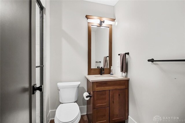 1000 Paradrome St, Cincinnati, OH 45202 - bathroom featuring vanity, toilet, an enclosed shower, and baseboards