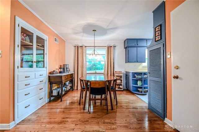 200 Maysfield Rd, Oakwood, OH 45419 - dining space featuring light wood-style floors, a chandelier, and ornamental molding