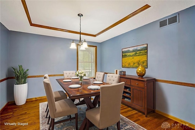 1235 Bruton Parish Way, Fairfield, OH 45014 - dining area featuring a raised ceiling, a chandelier, wood finished floors, and ornamental molding