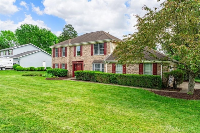 1747 Maple Ln, Beavercreek, OH 45432 - colonial-style house with a front lawn and brick siding