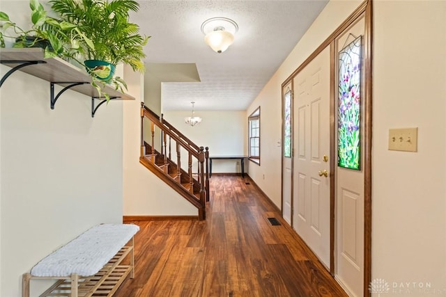 1747 Maple Ln, Beavercreek, OH 45432 - entryway featuring stairway, wood finished floors, a chandelier, and baseboards